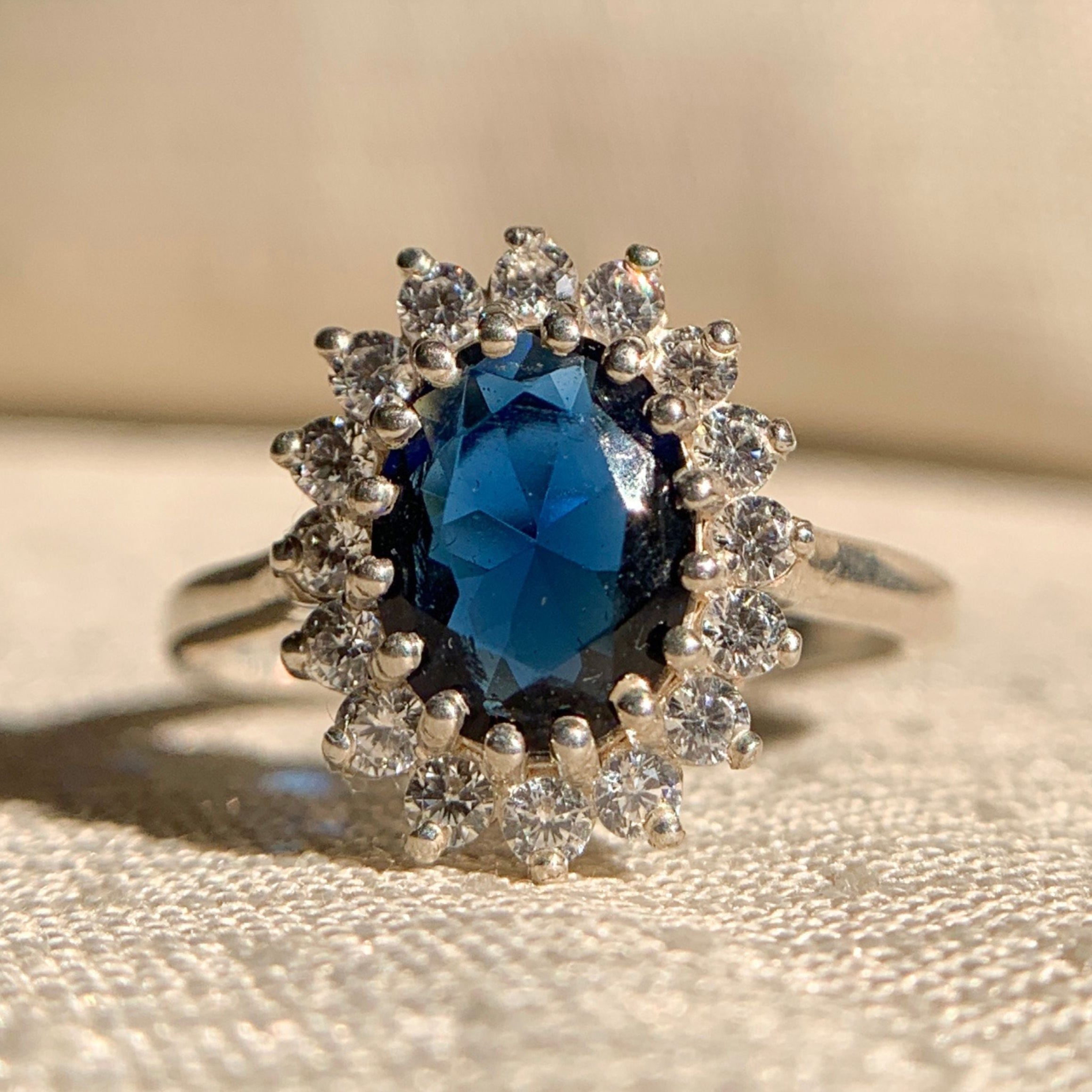 Oval cut blue sapphire engagement ring with diamond halo